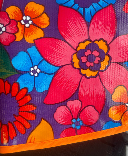 Round Purple Flora Oilcloth Tablecloths with Orange Bias Tape Trim